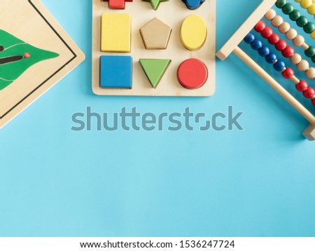 kids learning concept with stacking toys on blue table background.