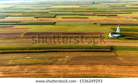 Lonely Chapel in Countryside and Farm Fields. Picturesque Rural Scene. Aerial Drone view.