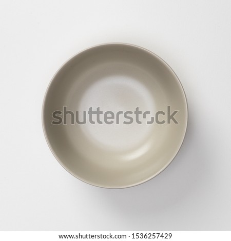 Empty blank white ceramic round bowl isolated on white background with shadow, Flat lay of traditional handcrafted kitchenware concept Royalty-Free Stock Photo #1536257429