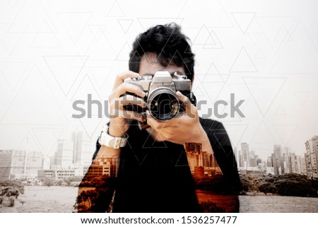 asian man photographer with old camera in city abstract background