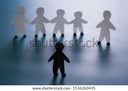 Racism concept image. White paper person agains black paper person Royalty-Free Stock Photo #1536260435