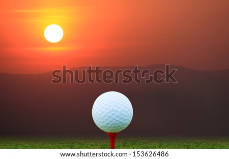Symbolic of success and preparedness victory the golf ball placed on the floor of the lawn in the game with a mountains and sun background. success concept.