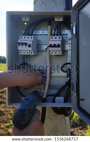 Installing and connecting an electrical panel on the street.