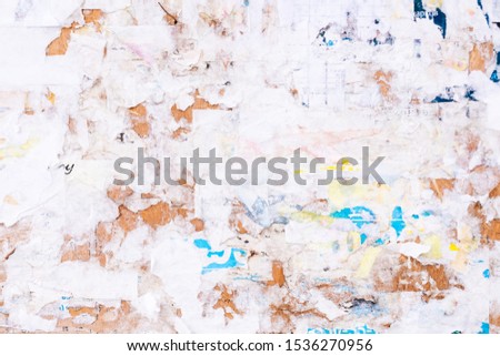Old Urban Billboard With Torn Peeled Poster Abstract Horizontal Background. Outdoor Bulletin Board Or Plywood Panel With Worn Advertising Message, Notice And Stickers Street Texture. Creative Surface