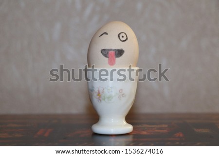 Drawing funny and cute face  on egg