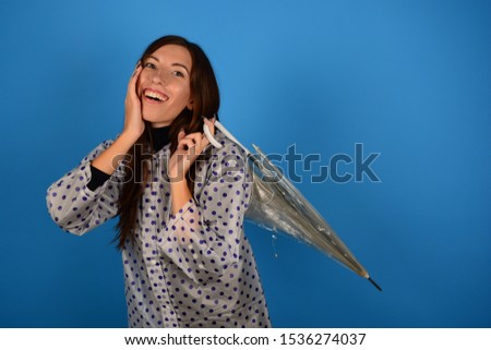 young woman joyful in a raincoat with a transparent umbrella autumn fresh