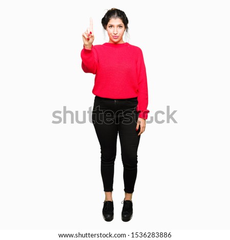 Young beautiful woman wearing red sweater and bun Pointing with finger up and angry expression