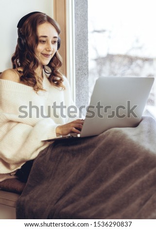 woman listening music with headphones. relax winter life