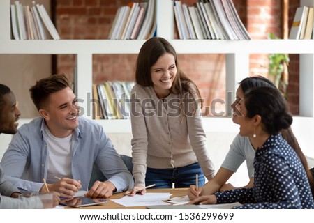 Group of multiracial student listen caucasian girl team leader do common task thinking together search solutions feels happy having friendly warm relations, teamwork racial equality leadership concept Royalty-Free Stock Photo #1536299699