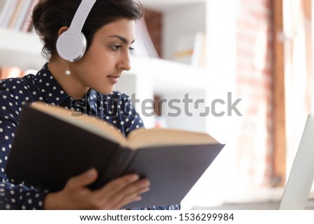 Indian woman prepare essay using textbook and internet online website, translator make translation using professional literature, self-education, teacher individual grow and improve knowledge concept