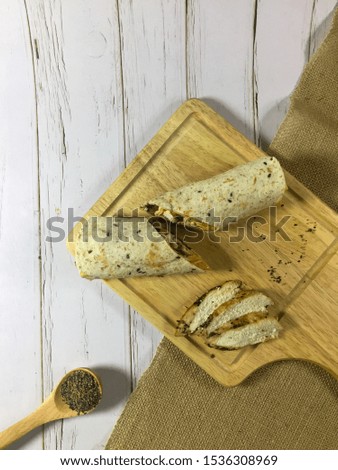 Bread wrapped in photographic concept. Some of the different angles and compositions are made up of bread wraps, grilled chicken, salads, and even black pepper powder.