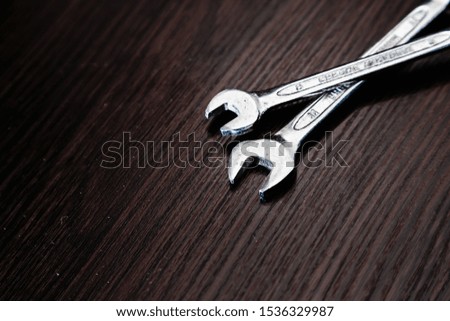Wrenches on a dark wooden background.  Close-up.