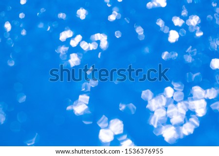 Bokeh blurred thin sheet of blue colour cellophane with shiny crumpled surface texture on white background, Abstract, Light & Shadow concept