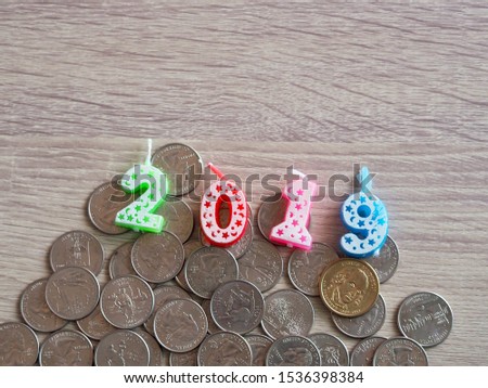 Number 2019 candle decorate on US dollar coin in concept money management on year 2019 before new year 2020