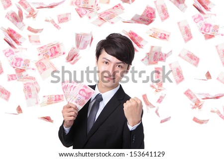 Happy business man hold China money ( Renminbi ) under a money rain - isolated over a white background, asian model