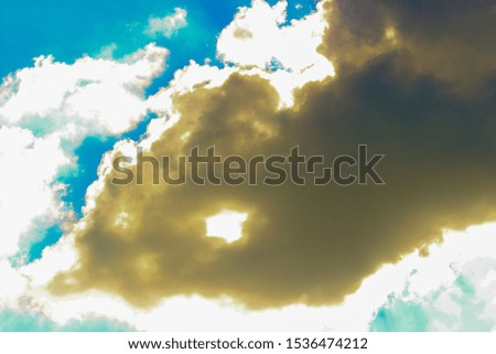 The sky and white clouds blocking the sun