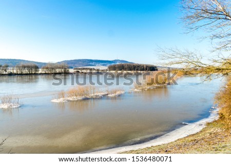 The Lentersheimer pond in front of the highest mountain in middle Franconia the Hesselberg in Bavaria Germany.