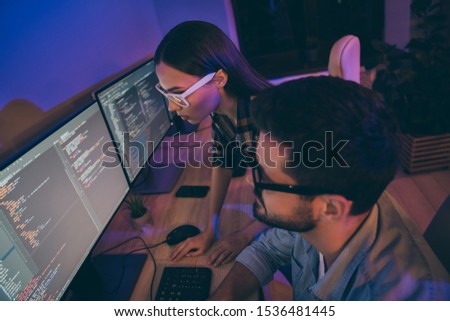 Profile photo of it specialist two guy lady business people night coworking together watch monitors correct errors bugs writing interface code office workplace indoors