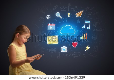 Adorable girl working on tablet with application and gadgets concept