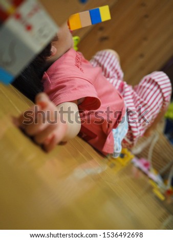 a three year old boy lying on the floor with toys Royalty-Free Stock Photo #1536492698