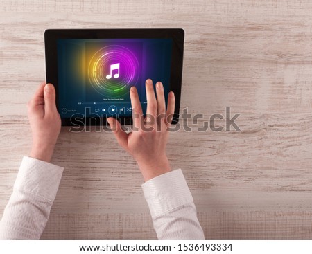 Hand touching tablet with music play concept