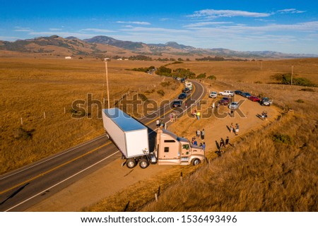 California Highway Traffic. Trucks and cars on the Highway 1 are stuck because of the accident. Huge truck blocked the road both ways. American transportation theme.