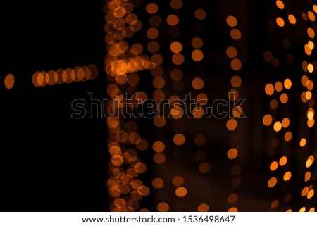Abstract Diwali blurred yellow orange vintage lights bokeh background defocused isolated in Black. Concept for greetings card, festive season, holiday banner & wallpaper.