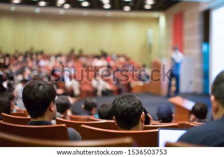 Conference photo audience and tech speaker giving speech. Seminar presenter at CEO forum. Corporate manager in executive training discussion on stage. Investor pitch presentation workshop picture.
