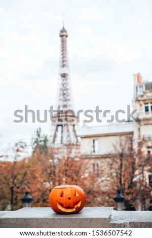 Halloween pumpking in the street of Paris with the view to the Eiffel tower. Preparation for Halloween party for tourists in Paris