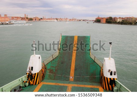 A car ferry approaches the city of Venice and the island La Giudecca (right). In the lagoon of Venice, Italy, Europe.