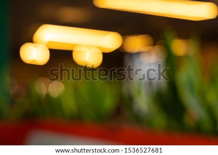 background fuzzy picture of unfocused cafe interior roof lamp illumination 