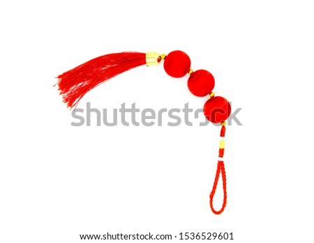 Chinese red knot with tassel, top view photo. Asian holiday symbol. Red silk knot isolated. Chinese New Year decoration. Oriental decor for prosperity and good luck. Japanese knot for lunar New Year
