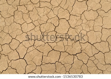 Clay sandy earth parched and cracked Royalty-Free Stock Photo #1536530783