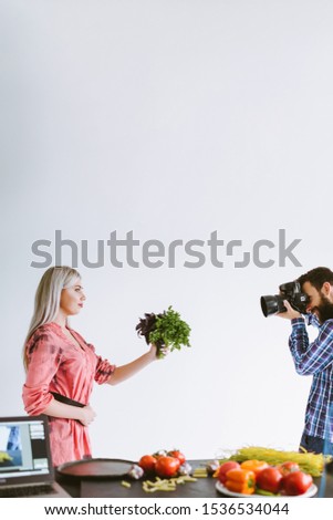 Professional food photography. Studio shooting. Woman with fresh herbs posing on white background.