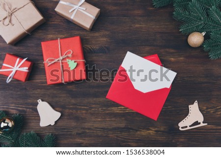 High angle close up above overhead view photo of creative bright envelope with paper card copyspace for text inside many packed giftboxed on rustic backdrop