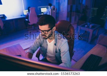 Photo of it specialist guy sitting chair seriously looking many monitors writing secure code for website calculate algorithms content development expert office indoors