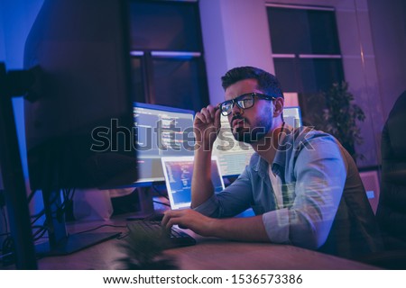 Profile photo of it specialist looking monitors testing website debugging system attentive developer expert creating new tasks for team sitting night office indoors Royalty-Free Stock Photo #1536573386