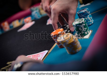 card player gambling casino chips on black felt background selective focus