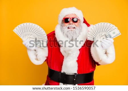 Credit bank x-mas lottery win. Funny funky white bearded santa claus hold double money jackpot fan become north-pole millionaire wear red hat headwear isolated over yellow color background