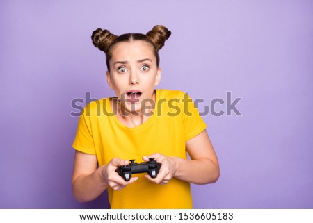 Photo of pretty lady holding joystick addicted to video games trying hard not believe it will be failure wear yellow t-shirt isolated pastel purple background