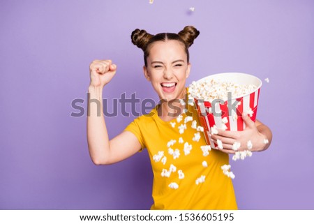 Photo of pretty lady holding paper popcorn container yelling joyful best film final throwing corns out of bucket wear yellow t-shirt isolated pastel purple background