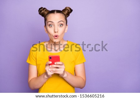 Photo of pretty lady open mouth holding telephone reading positive comment in social blog wear yellow t-shirt isolated on pastel purple background