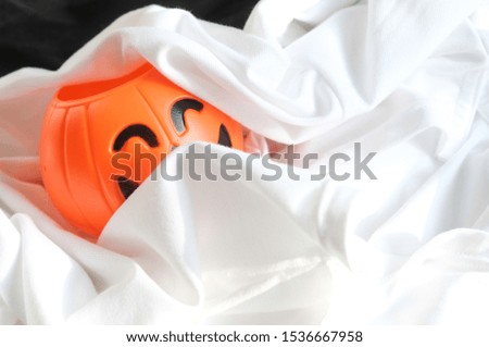Cute Halloween pumpkins are sleeping happily on the white cloth.