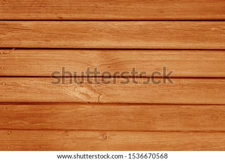 Old grungy wooden planks background in orange color. Abstract background and texture for design.