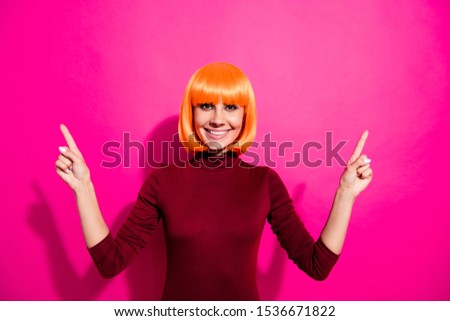 Photo of funny lady in bright wig advertising new prices shown at billboard wear red turtleneck isolated pink color background