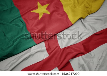 waving colorful flag of england and national flag of cameroon. macro