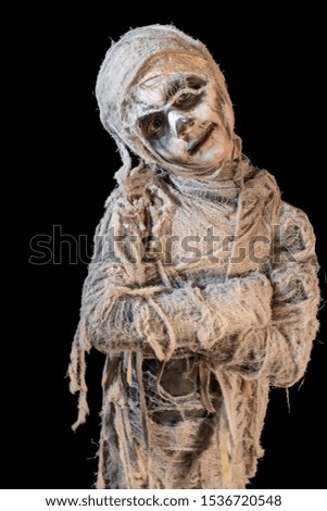 studio shot portrait of young boy in costume dressed as a Halloween, cosplay of scary mummy pose on isolated black background