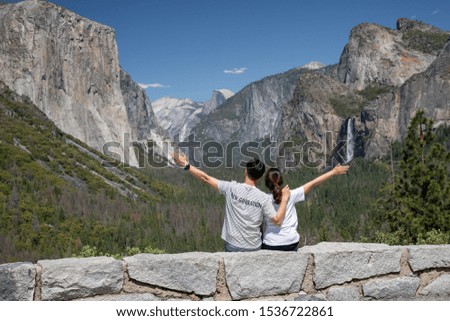 Classic Tunnel View of scenic Yosemite Valley with famous El Capitan and Half Dome and couple in summer, Yosemite National Park, California, USA