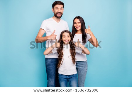 Portrait of cheerful positive three brunet hair people promoters show thumb up recommend sales wear white t-shirt denim jeans casual outfit isolated over blue color background