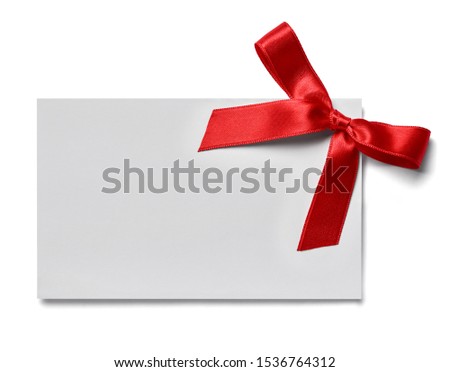 close up of a greeting card note with red ribbon on white background